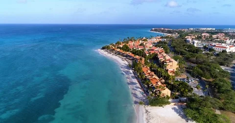 Empty beach Cinematic fly out up high white beach coast line with hotels Stock-Footage 95766142