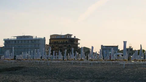 An empty beach with closed sunshades and deck chairs in Caorle, Veneto, Italy. Stock Footage 157374268