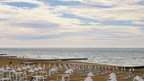 Empty beach with closed umbrellas before rain Stock Footage 313844654