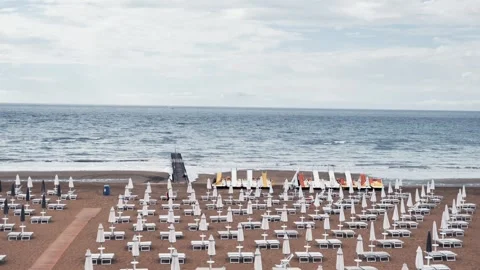 Empty beach with closed umbrellas before rain Stock Footage 313844745