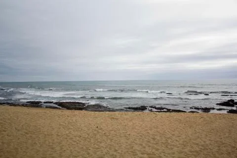 Empty beach on a cloudy day Stock Photos