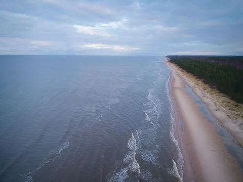 Empty beach Coastline with breaking waves on cloudy day Stock Footage 84296277