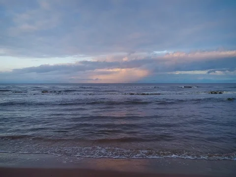 Empty beach Coastline with breaking waves on cloudy day Stock Footage 84296283
