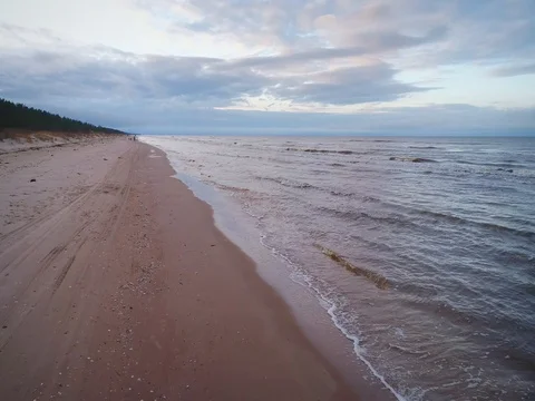 Empty beach Coastline with breaking waves on cloudy day Stock Footage 84296301
