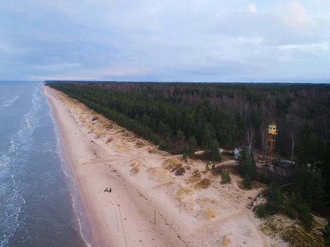 Empty beach Coastline with breaking waves on cloudy day Stock Footage 84296394