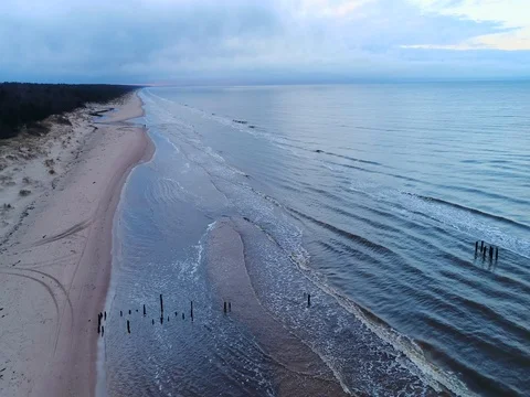 Empty beach Coastline with breaking waves on cloudy day Stock Footage 84296527