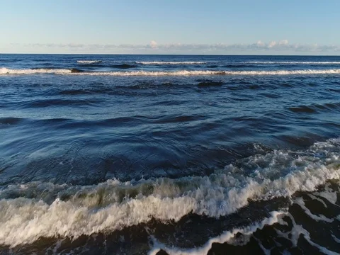 Empty beach Coastline with breaking waves on cloudy day Stock Footage 84296749
