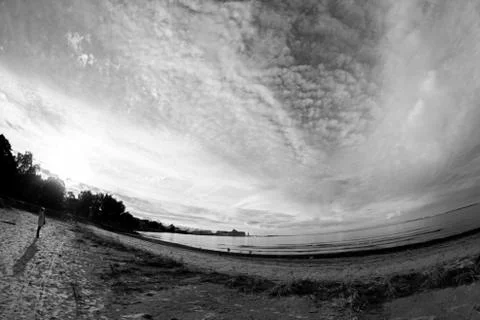 Empty beach with dark clouds above Stock Photos