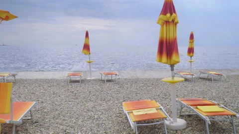 Empty beach deck chair, sea ​​lounger, wind and rough sea. Stock Footage 161133969