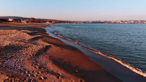 Empty beach with footprints at morning. Wide sandy shore with gentle waves and Stock Footage 324868299