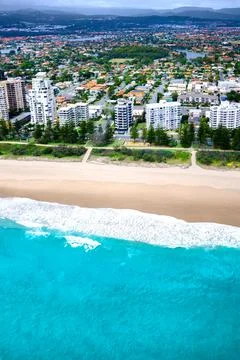 Empty beach in front of a city Stock Photos