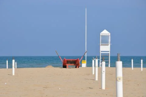 Empty beach with guard tower and rescue boat in Rimini Stock Photos