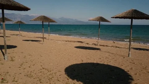 Empty beach with lonely umbrellas Stock-Footage 82868988