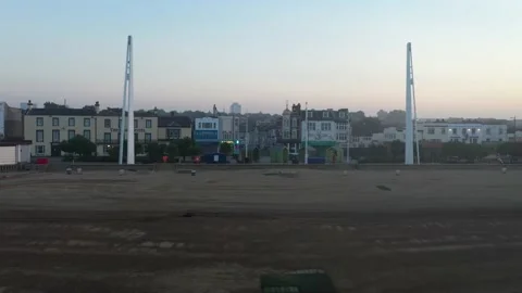 Empty beach at low tide in morning, buildings on waterfront Video stock 161016401
