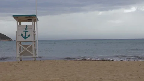 Empty beach in Magaluf in Mallorca with a deserted life guard tower Stock Footage 130146624