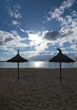 Empty beach with parasols Stock Photos