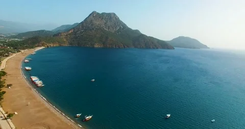 Empty Beach, Parked Yachts in Bay Drone Shot Stock Footage 130599624