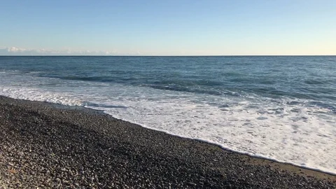 An empty beach with pebbles and blue sea in Liguria region in Italy in autumn. Stock Footage 86132376
