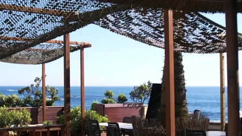 Empty beach restaurant with lots of plants, tables and chairs in summer. Stock Footage 274765160