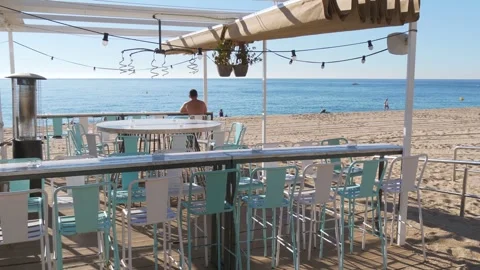 Empty beach restaurant terrace with ocean view on sunny day. Stock Footage 337807578