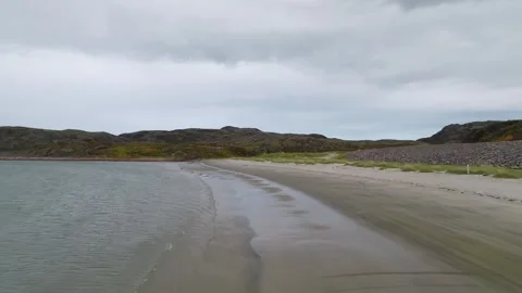 Empty beach shoreline with cloudy sky filmed by drone Stock Footage 309322188
