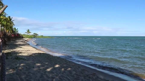 Empty beach with a small strip of sand and a child in the water at the end Stock Footage 172028337