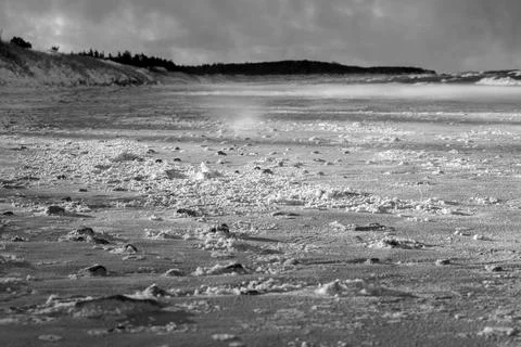Empty beach with snow and wind in winter Stock Photos