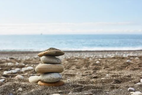 Empty beach with a stack of rocks Stock Photos
