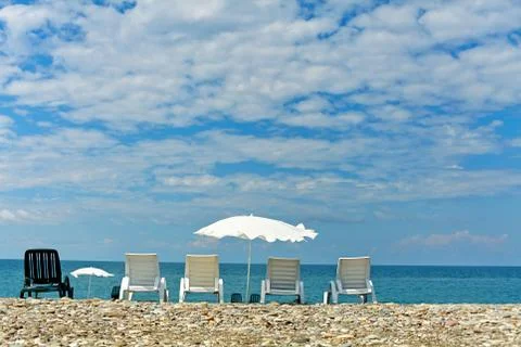 Empty beach with sunbeds Stock Photos