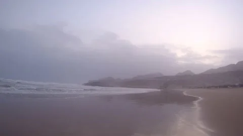 Empty beach at sunset times near the mountains Stock Footage 159350762