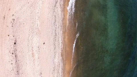 Empty beach. Top down, aerial view. Drone rise up above coastline Video stock 126618800