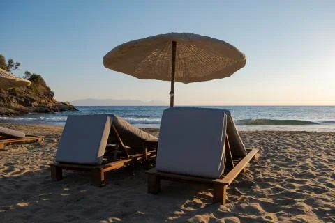 Empty beach - two empty sunbed on empty beach Stock Photos
