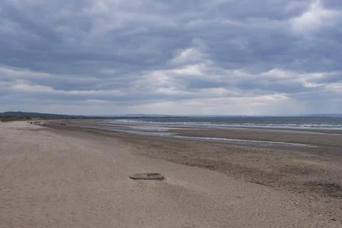 Empty beach under cloudy sky Stock Photos
