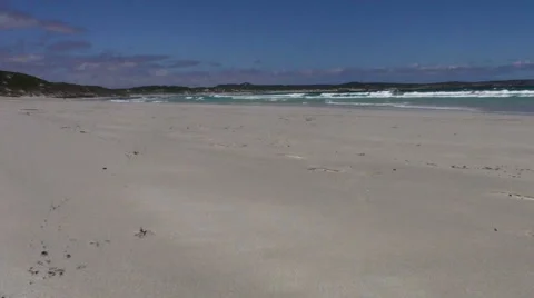 Empty beach with white sand and waves rolling in Stock Footage 976382
