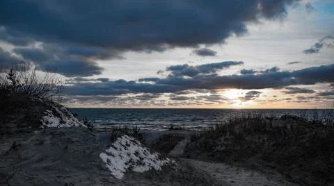 Empty beach wind with tree line against the cloudy sky sunset in Palanga city Stock Photos