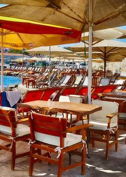 Empty beachfront restaurant offering refreshments under umbrellas Stock Photos