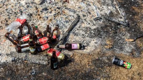 Empty bear bottles in fire place ach Stock Photos