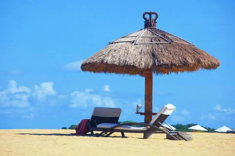 Empty beautiful idylic beach background with recliners, chairs, exotic straw Stock Photos