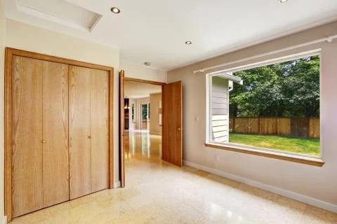 Empty bedroom interior with large window and marble tile floor Stock Photos