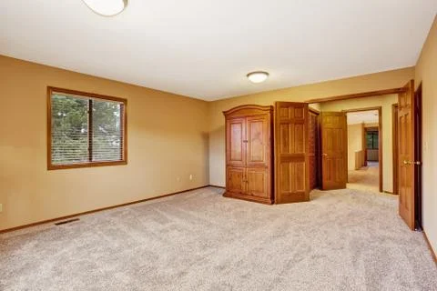 Empty bedroom interior in soft peach color with wardrobe Stock Photos