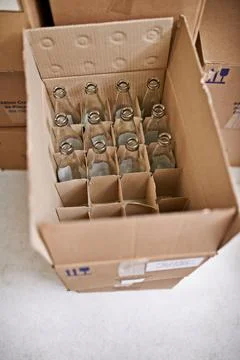 Empty beer bottle, box and storage in factory on floor, above and container for Foto stock