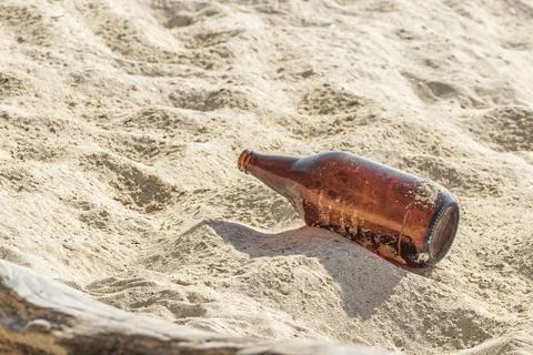 Empty beer bottle garbage pollution beach Playa del Carmen Mexico. Stock Photos