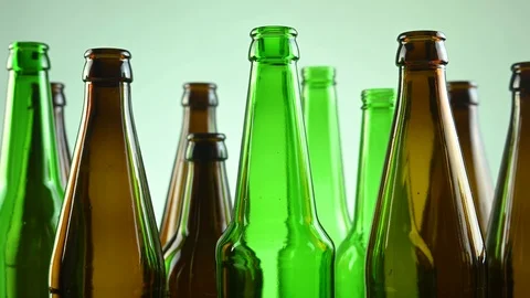 Empty beer bottles stand on a white background Stock Footage 124547571
