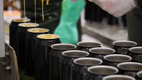 Empty beer cans are filled with fruit beer at the brewery's filling line. Close Video stock 149664682