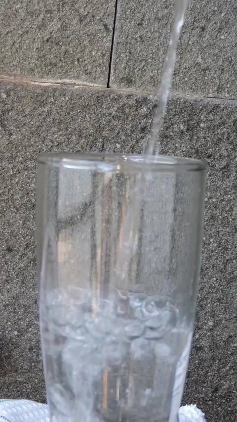 An empty beer glass is filled with refreshing water during the day Stock Footage 285718347