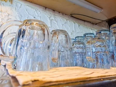 Empty beer glasses ready for use in the bar with clean glasses ready for beer Stock Photos