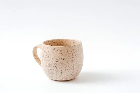 Empty beige coffee ceramic cup on isolated white background, cut out Foto stock