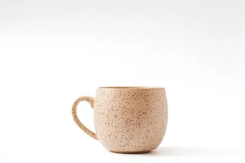 Empty beige coffee ceramic cup on isolated white background, cut out Foto stock