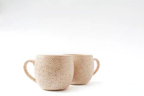 Empty beige coffee ceramic cups on isolated white background, cut out Stock Photos