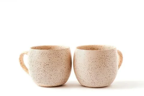 Empty beige coffee ceramic cups on isolated white background, cut out Stock Photos